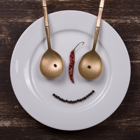 Happy smiley face on dish plateの写真素材