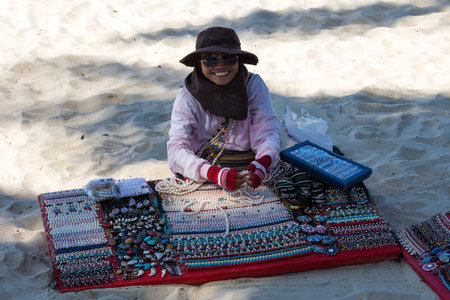 KOH CHANG, THAILAND - NOVEMBER 3 : Unidentified Thai woman sells jewelery to tourists on the beach on November 3, 2013 in Koh Chang Island, Thailand. . Daily life of local people on island.のeditorial素材