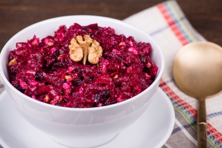 Fresh salad with beet and walnuts on white plateの写真素材