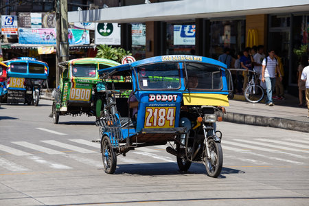 DUMAGUETE, PHILIPPINES - FEBRUARY 18, 2014 :Tricycle motor taxi, Philippines inexpensive transport service. Tricycle motor taxi are the most popular means of public transportation in the Philippines.のeditorial素材