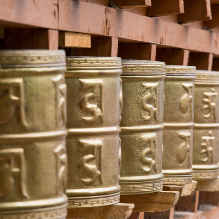 Buddhist prayer wheels in Tibetan monastery with written mantra. India, Himalaya, Ladakhの写真素材