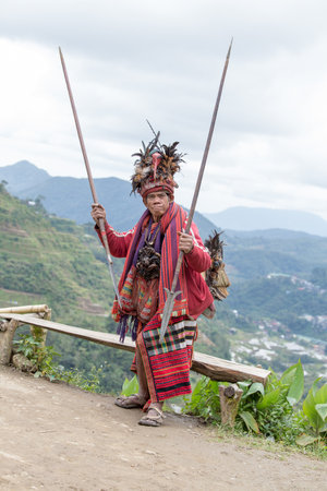 BANAUE, PHILIPPINES - JANUARY 24, 2014 : Unknown old ifugao man in national dress next to rice...