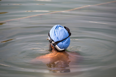 AMRITSAR, INDIA - SEPTEMBER 27, 2014: Unidentified Sikh man visiting the Golden Temple in Amritsar, Punjab, India. Sikh pilgrims travel from all over India to pray at this holy site.のeditorial素材