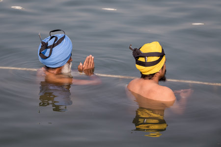 AMRITSAR, INDIA - SEPTEMBER 28, 2014: Unidentified Sikhs men visiting the Golden Temple in Amritsar, Punjab, India. Sikh pilgrims travel from all over India to pray at this holy site.のeditorial素材