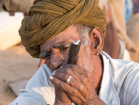 PUSHKAR, INDIA - OCTOBER 27, 2014: Unidentified Indian man attended the annual Pushkar Camel Mela....