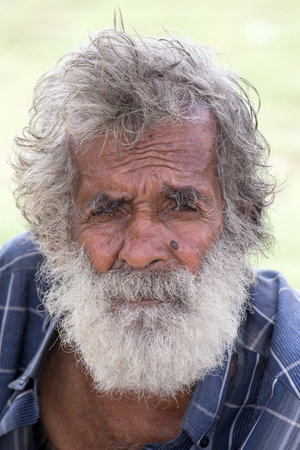 MATARA, SRI LANKA - NOVEMBER 5, 2014: Unidentified old Sri Lankan beggar waits for alms on a street next to the bus stationのeditorial素材