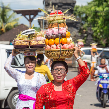 UBUD, BALI, INDONESIA - MARCH 19, 2015 : Unidentified Indonesian people celebrate Balinese New Year and the arrival of spring. Balinese women bring offerings of fruits and gifts to the village templeのeditorial素材