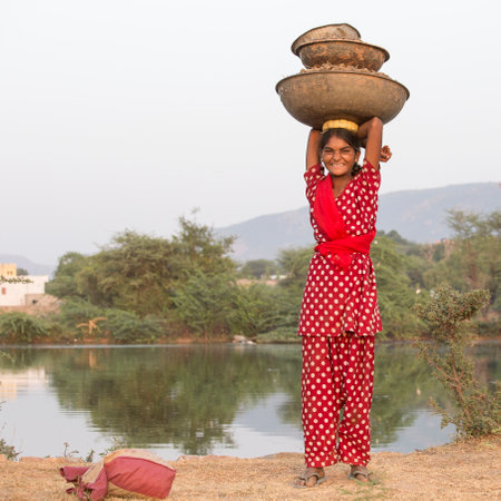 PUSHKAR, INDIA - OCTOBER 27, 2014: Unidentified girl at the attended the annual Pushkar Camel Mela. This fair is the largest camel trading fair in the world.のeditorial素材