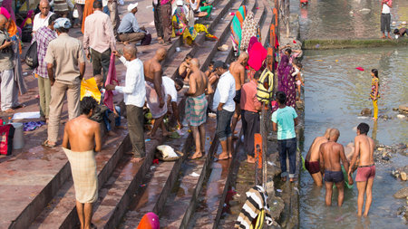 HARIDWAR, INDIA - OCTOBER 21, 2014: Unidentified Indian people at ritual washing in the sacred Ganges river. Haridwar - famous worship place in Indiaのeditorial素材