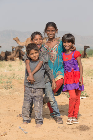 PUSHKAR, INDIA - OCTOBER 26, 2014 : Unknown children and camel involved in Pushkar Camel Mela, Pushkar Camel Fair. This fair is the largest camel trading fair in the world.のeditorial素材