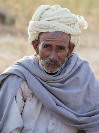 PUSHKAR, INDIA - OCTOBER 28, 2014: Unidentified Indian man attended the annual Pushkar Camel Mela. This fair is the largest camel trading fair in the world.のeditorial素材