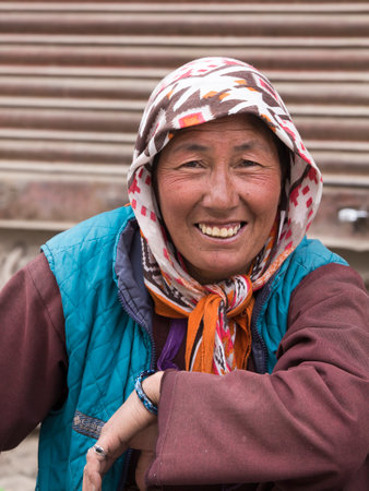LEH, INDIA - JUNE 21, 2015: Unknown beggar woman begging on the street in Leh, Ladakh. Poverty is a major issue in Indiaのeditorial素材