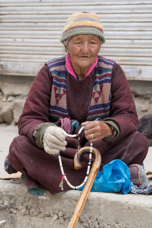 LEH, INDIA - JUNE 21, 2015: Unidentified beggar woman on the street in Leh, Ladakh. Poverty is a major issue in Indiaのeditorial素材