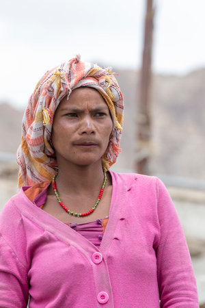 LEH, INDIA - JUNE 24, 2015: Unknown beggar woman begging on the street in Leh, Ladakh. Poverty is a major issue in Indiaのeditorial素材