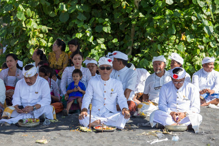 UBUD, BALI, INDONESIA - MARCH 19, 2015 : Unidentified Indonesian people celebrate Balinese New Year and the arrival of spring. People praying at Ketewel beach during the religious ceremonyのeditorial素材