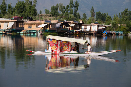 SRINAGAR, INDIA - JULY 03, 2015 : Lifestyle in Dal lake, local people use 'Shikara', a small boat for transportation in the lake of Srinagar, Jammu and Kashmir state, Indiaのeditorial素材