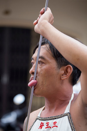 PHUKET, THAILAND - OCT 18, 2015: Chinese thai monk possessed by his god walks with his mouth pierced in Vegetarian Festival at Phuket Town. Festival is a famous annual also known as Nine Emperor Godsのeditorial素材