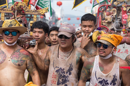 PHUKET, THAILAND - OCT 18, 2015: Chinese thai monk possessed by his god walks with his mouth pierced in Vegetarian Festival at Phuket Town. Festival is a famous annual also known as Nine Emperor Godsのeditorial素材