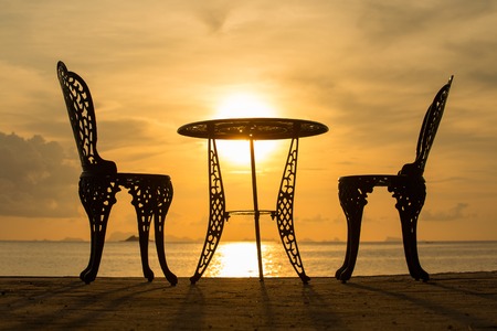 Table and two chairs on a tropical beach during sunset. Koh Phangan, Thailand. Close upの写真素材