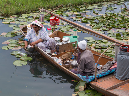 SRINAGAR, INDIA - JULY 09, 2015 : Lifestyle in Dal lake, local people use 'Shikara', a small boat for transportation in the lake of Srinagar, Jammu and Kashmir state, Indiaのeditorial素材