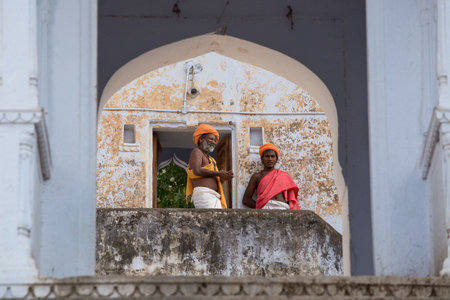 PUSHKAR, INDIA - OCTOBER 23, 2014: Unidentified Indian men on the ghat along the sacred Sarovar lake. Pushkar - famous worship place in Indiaのeditorial素材