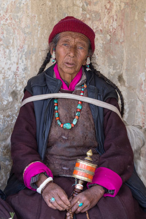 LAMAYURU, INDIA - JUNE 15, 2015: Unidentified buddhist old women during mystical mask dancing Tsam...