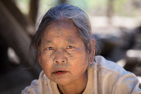 MRAUK-U, MYANMAR - JANUARY 27, 2016: The portrait of Chin woman with spider tattoo. Chin people,...