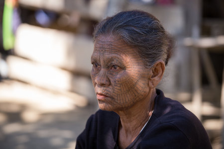 MRAUK-U, MYANMAR - JANUARY 27, 2016: The portrait of Chin woman with spider tattoo. Chin people, also known as the Kukis are a number of Tibeto Burman tribal people.のeditorial素材