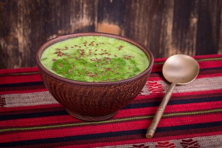 Green cream soup from spinach on table, close upの写真素材