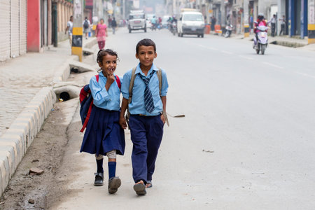 KATHMANDU, NEPAL - SEPTEMBER 29, 2016 : Young boy and girl going home from school after lessons at the local school in Kathmandu, Nepalのeditorial素材