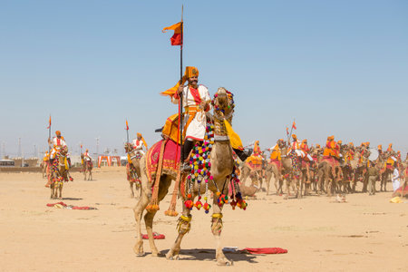 JAISALMER, INDIA - FEBRUARY 09, 2017 : Camel and indian men wearing traditional Rajasthani dress participate in Mr. Desert contest as part of Desert Festival in Jaisalmer, Rajasthan, Indiaのeditorial素材