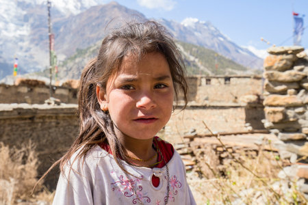 HIMALAYAS, ANNAPURNA REGION, NEPAL - OCTOBER 17, 2016 : Portrait nepalese child on the street in Himalayan village, Nepalのeditorial素材