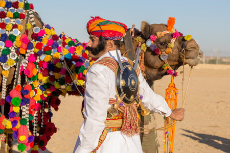 JAISALMER, INDIA - FEBRUARY 09, 2017 : Camel and indian men wearing traditional Rajasthani dress participate in Mr. Desert contest as part of Desert Festival in Jaisalmer, Rajasthan, Indiaのeditorial素材