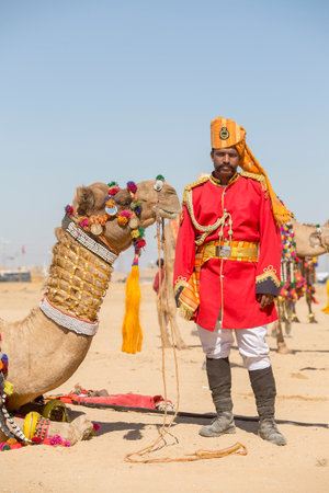 JAISALMER, INDIA - FEBRUARY 09, 2017 : Camel and indian men wearing traditional Rajasthani dress participate in Mr. Desert contest as part of Desert Festival in Jaisalmer, Rajasthan, Indiaのeditorial素材