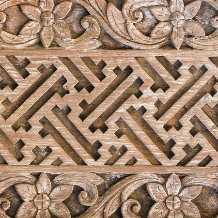 Detail of a beautiful carved wooden door of a temple in Ubud, Bali, Indonesia . Close up