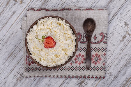 Cottage cheese and red strawberry on the table. Close upの写真素材