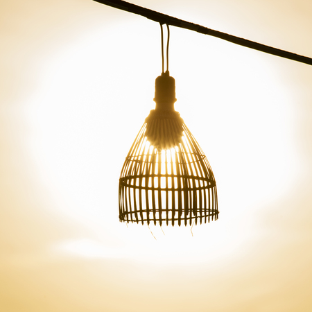 Silhouette of a lamp on the wire at sunset in island Koh Chang, Thailandの写真素材