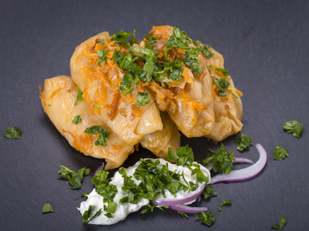 Ukrainian and Russian dishes - homemade stuffed cabbage rolls with rice and meat in tomato sauce on...