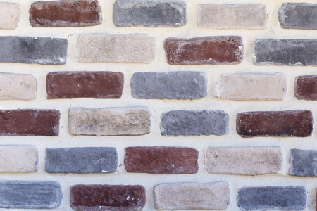 Abstract multicolored painted brick wall background, close up
