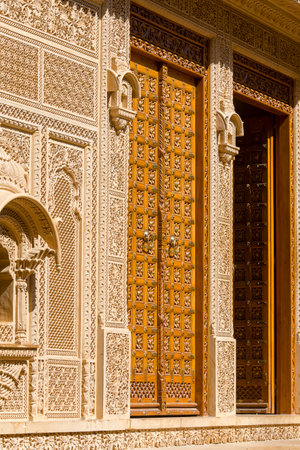 Wooden door and ornament on wall of palace in Jaisalmer fort, India. Close upのeditorial素材