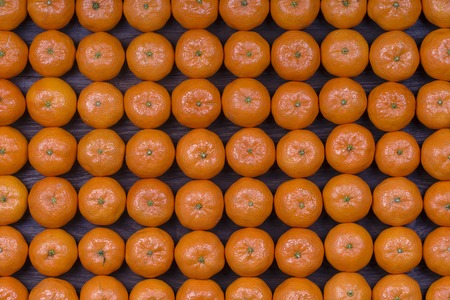 Fresh orange, tangerine fruit, mandarin pattern background, close up, top viewの写真素材
