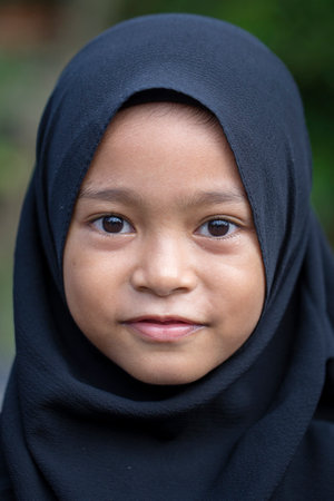 UBUD, BALI, INDONESIA - JANUARY 02, 2018 : Unidentified portrait of a little indonesian muslim girl at the streets in Ubud, island Bali, Indonesia, close upのeditorial素材