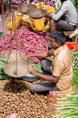 MATARA, SRI LANKA - NOVEMBER 5, 2014: Unidentified sellers in street market sell fresh fruits and vegetables. Many people buy fresh food on the street rather than at shops.のeditorial素材