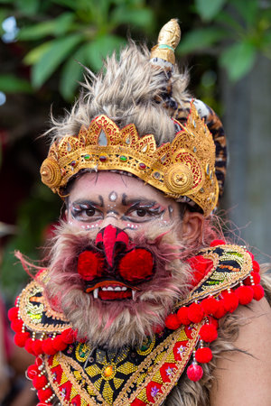GIANYAR, BALI, INDONESIA - JANUARY 08, 2018 : Balinese man dressed in the mask of Hanuman for street...