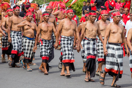 GIANYAR, BALI, INDONESIA - JANUARY 08, 2018 :Unknown Balinese old men participates in street ceremony, during a pre-election rally the Indonesian Democratic Party of Struggle in island Bali, Indonesiaのeditorial素材