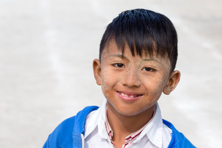 INLE LAKE, MYANMAR - JANUARY 11, 2016: Unidentified young boy with thanaka on face in local school