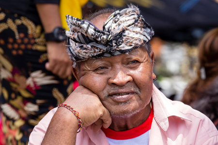 GIANYAR, BALI, INDONESIA - JANUARY 08, 2018 :Unknown Balinese old man participates in street ceremony, during a pre-election rally the Indonesian Democratic Party of Struggle in island Bali, Indonesiaのeditorial素材