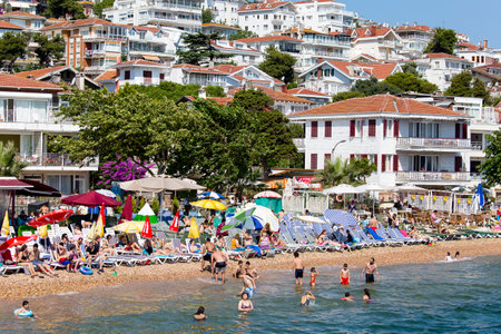 PRINCES ISLANDS, TURKEY - JULY 18, 2015 : View from the ferry, which runs along the route Istanbul - Buyukada. Architecture and tourists on the island Kinaliadaのeditorial素材