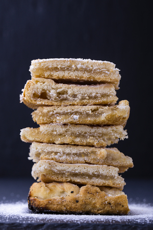 Homemade organic apple pie dessert ready to eat on the background of black slate , close up