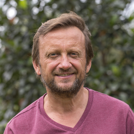 Portrait of an unshaven middle-aged man relaxing on the nature in summer day, close up